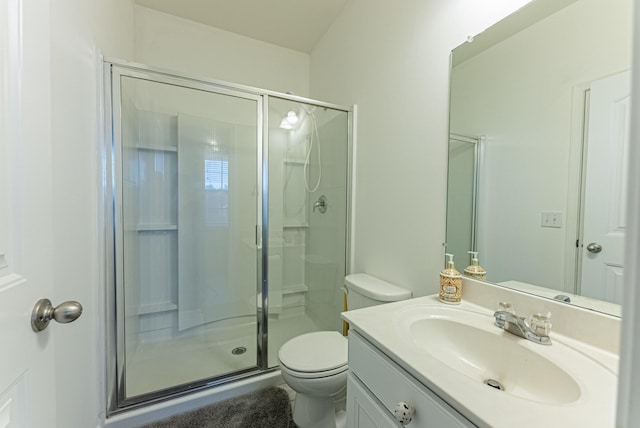 bathroom featuring vanity, toilet, and a shower with shower door