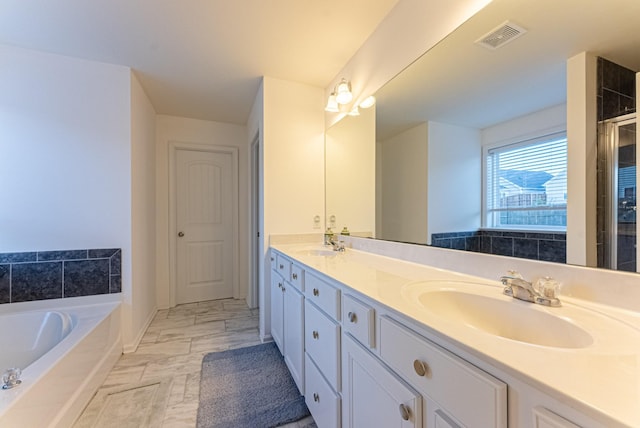 bathroom with vanity and a tub