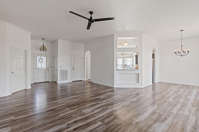 unfurnished living room featuring dark hardwood / wood-style flooring, ceiling fan with notable chandelier, and crown molding