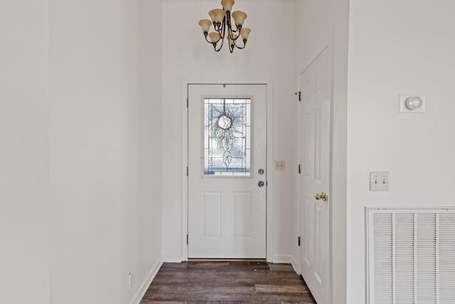 doorway featuring dark hardwood / wood-style floors and an inviting chandelier