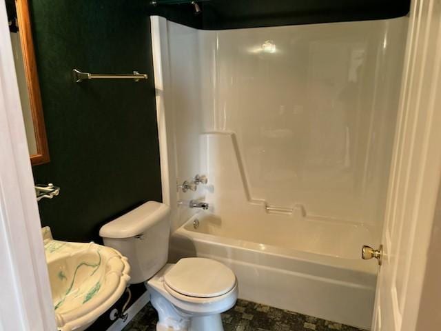 bathroom featuring shower / bathing tub combination and toilet