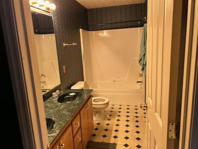 full bathroom with shower / tub combination, vanity, and toilet