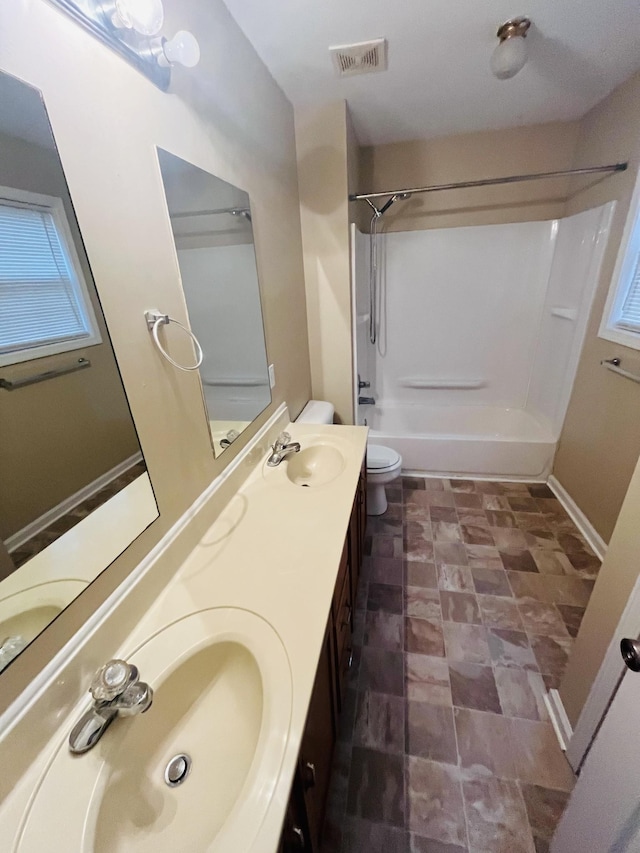 full bathroom featuring bathtub / shower combination, vanity, and toilet