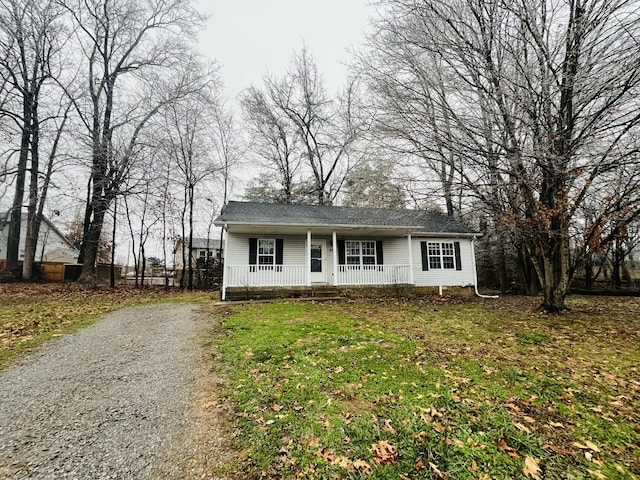 ranch-style house with a front lawn and covered porch