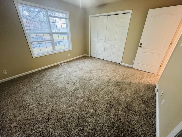 unfurnished bedroom featuring a closet and carpet