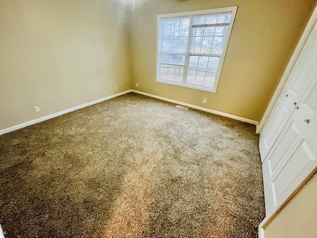 carpeted empty room with plenty of natural light