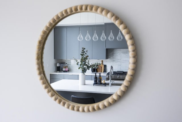 interior details featuring decorative backsplash and stainless steel gas range oven