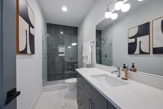 bathroom featuring vanity, toilet, and a shower with door