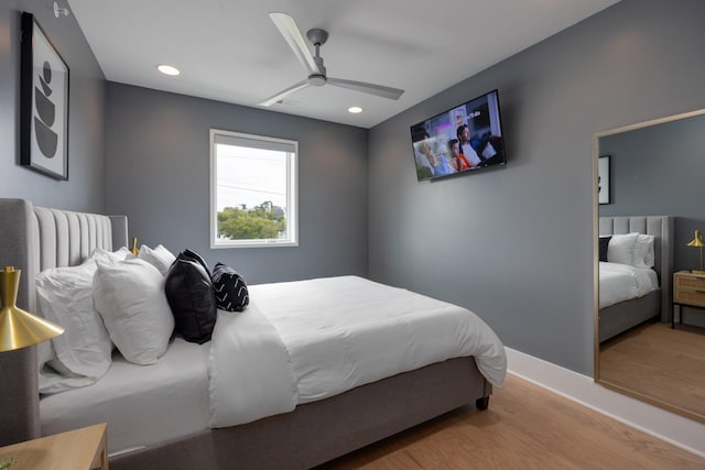 bedroom with ceiling fan and hardwood / wood-style floors