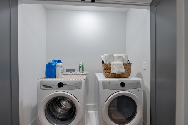 clothes washing area with separate washer and dryer