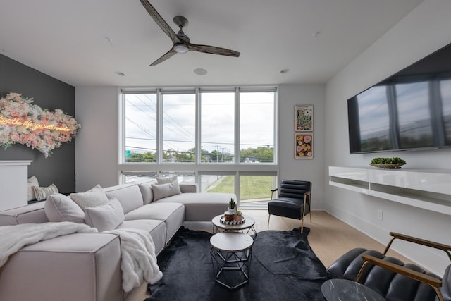 living room featuring a wall of windows, hardwood / wood-style flooring, a wealth of natural light, and ceiling fan