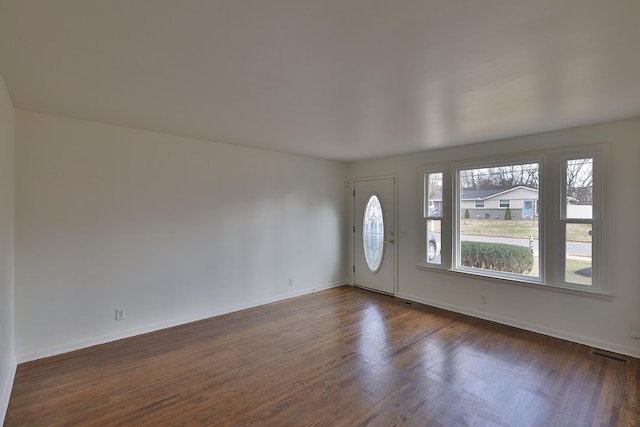 entryway with dark hardwood / wood-style flooring