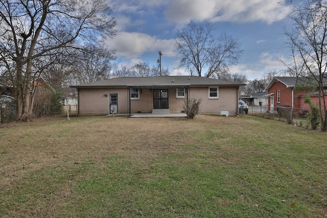 back of property featuring a yard and a patio