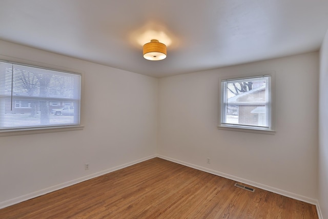 spare room featuring hardwood / wood-style flooring