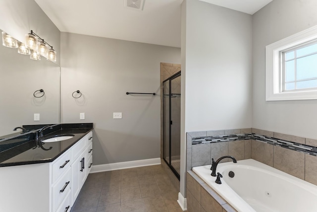 bathroom featuring tile patterned flooring, vanity, and shower with separate bathtub