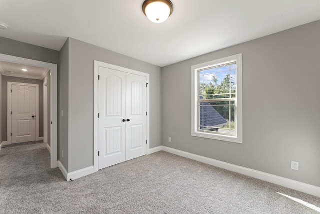 unfurnished bedroom featuring carpet floors and a closet