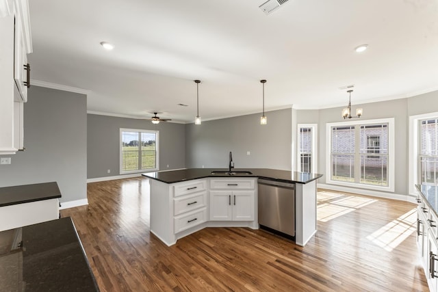 kitchen featuring dishwasher, ceiling fan with notable chandelier, sink, hanging light fixtures, and white cabinetry