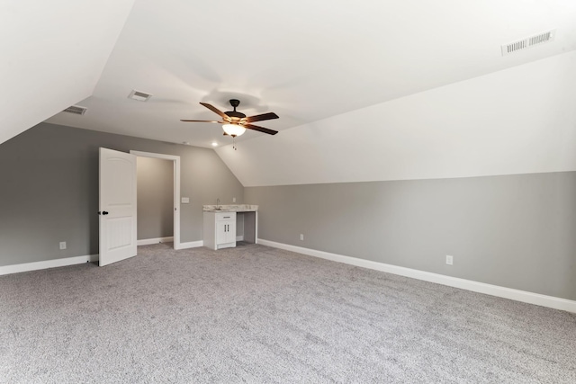 bonus room with carpet, vaulted ceiling, and ceiling fan