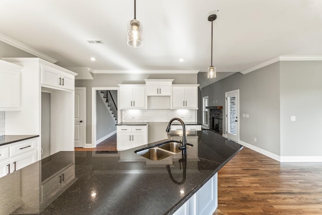 kitchen featuring decorative backsplash, sink, and decorative light fixtures