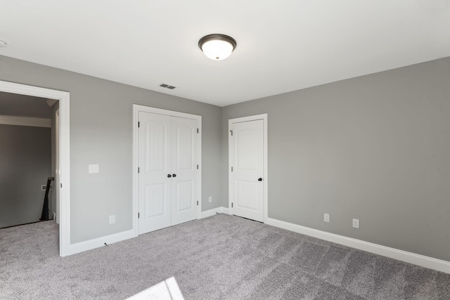 unfurnished bedroom featuring a closet and carpet floors