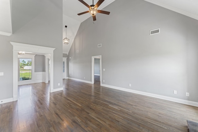 unfurnished living room featuring dark hardwood / wood-style flooring, ceiling fan with notable chandelier, high vaulted ceiling, and ornamental molding