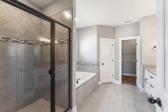 bathroom featuring tile patterned flooring, vanity, and independent shower and bath