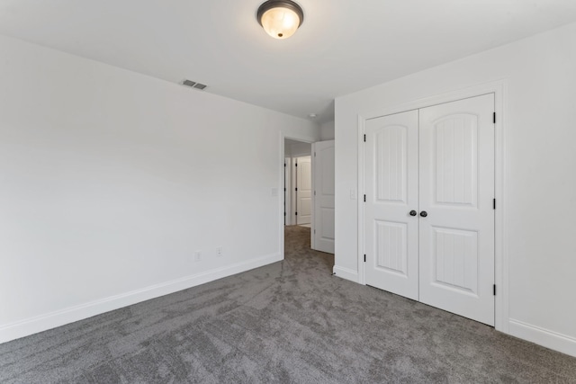 unfurnished bedroom featuring carpet floors and a closet