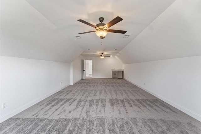 bonus room featuring ceiling fan, light carpet, and vaulted ceiling