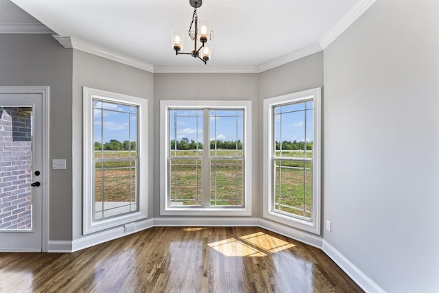 interior space with dark wood-type flooring, a wealth of natural light, and a notable chandelier