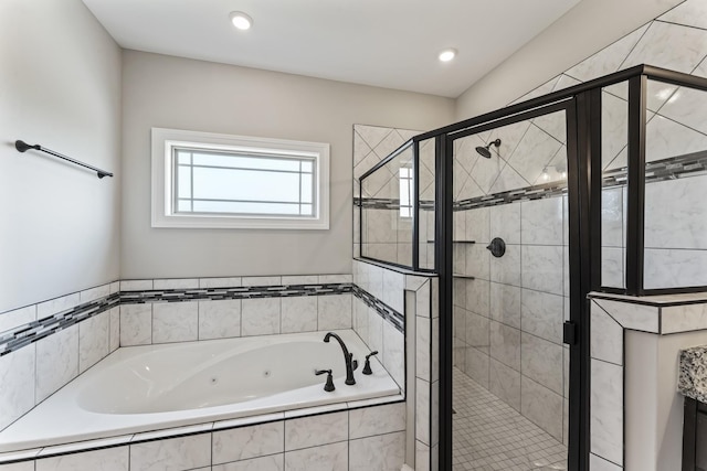 bathroom featuring shower with separate bathtub