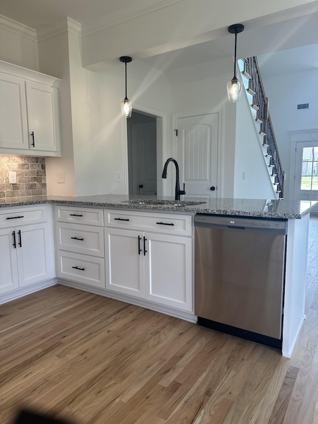 kitchen featuring dishwasher, decorative light fixtures, white cabinetry, and sink