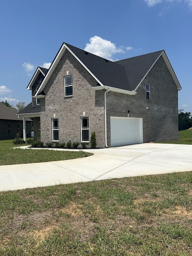 view of front of house with a front yard and a garage