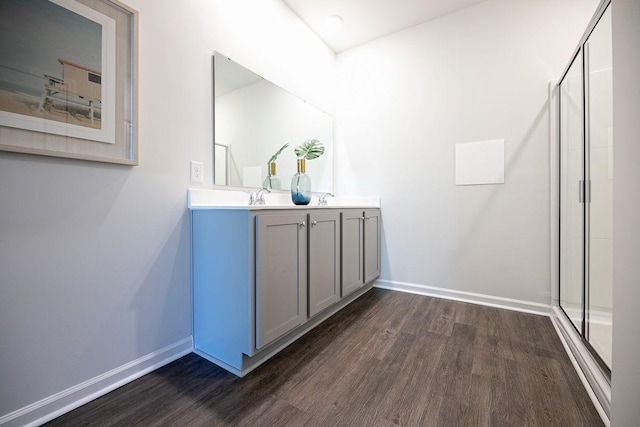 bathroom featuring hardwood / wood-style floors, vanity, and an enclosed shower