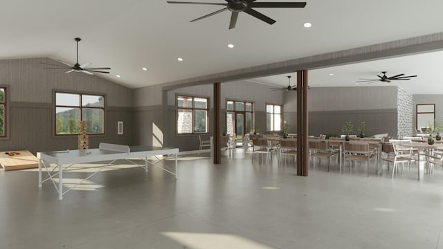 interior space featuring plenty of natural light, vaulted ceiling, ceiling fan, and concrete floors