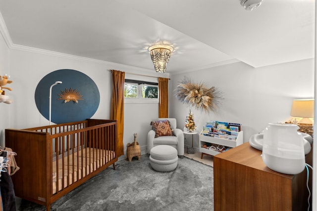 bedroom featuring crown molding, carpet, and a crib