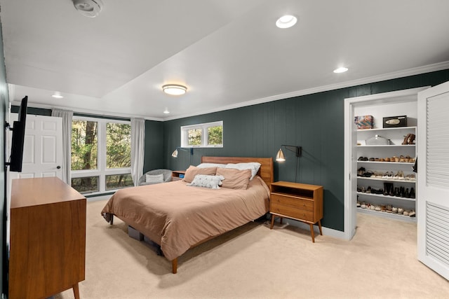 bedroom with light colored carpet and ornamental molding