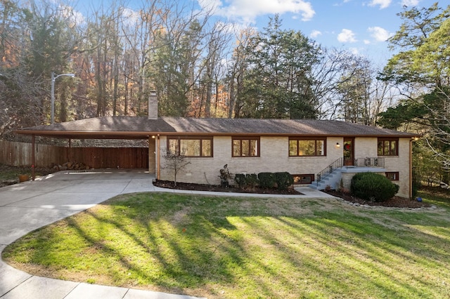 ranch-style home with a front yard and a carport