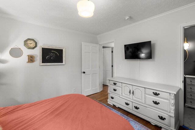 bedroom with crown molding, dark hardwood / wood-style floors, and a textured ceiling