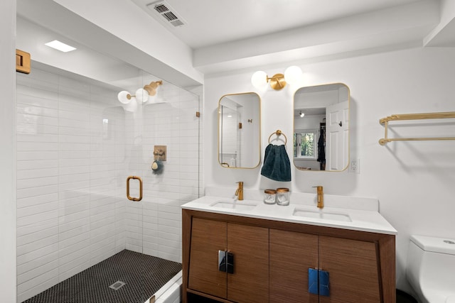 bathroom featuring vanity, an enclosed shower, and toilet