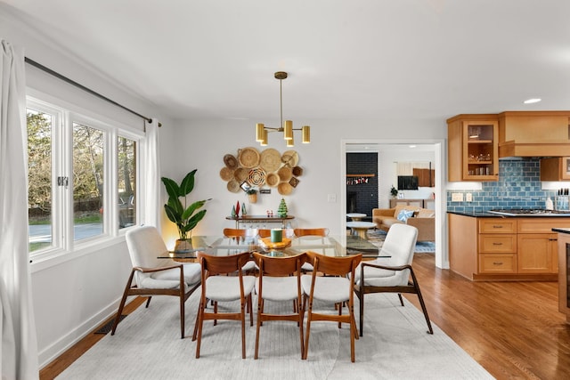 dining area featuring light hardwood / wood-style flooring and an inviting chandelier