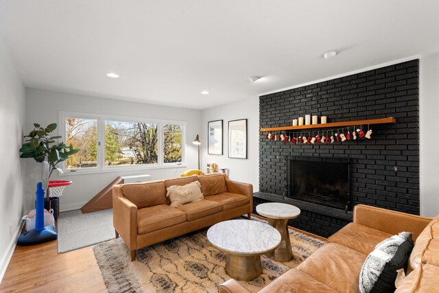 living room with wood-type flooring and a fireplace