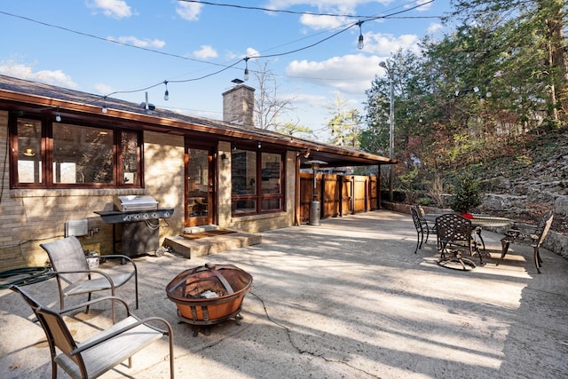 view of patio / terrace with an outdoor fire pit and a grill