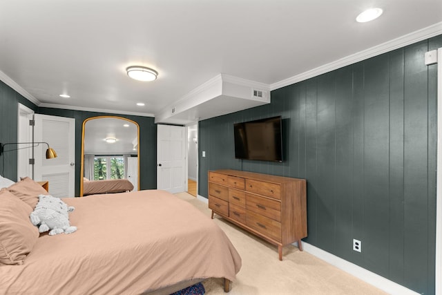 carpeted bedroom with wooden walls and ornamental molding