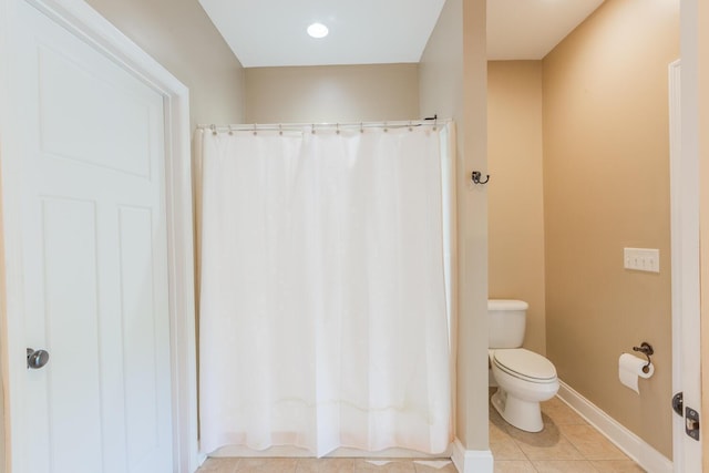 bathroom featuring tile patterned flooring and toilet