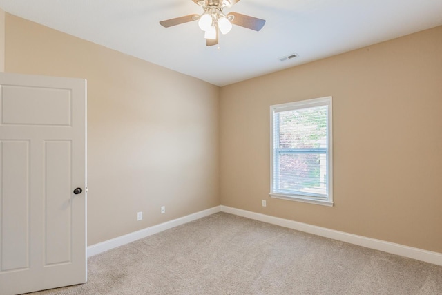 spare room featuring ceiling fan and light carpet