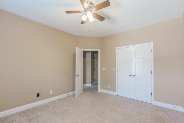 unfurnished bedroom featuring ceiling fan and light carpet