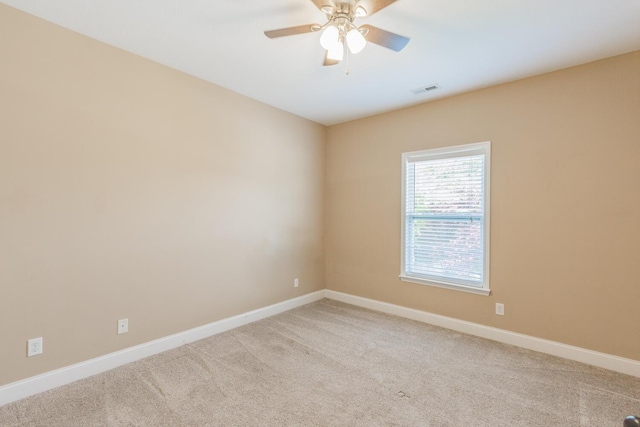 carpeted spare room featuring ceiling fan