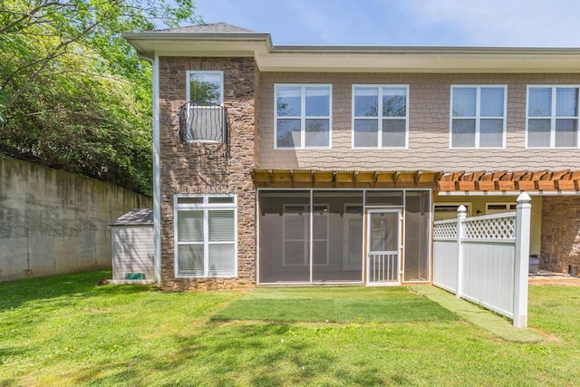 rear view of property with a yard