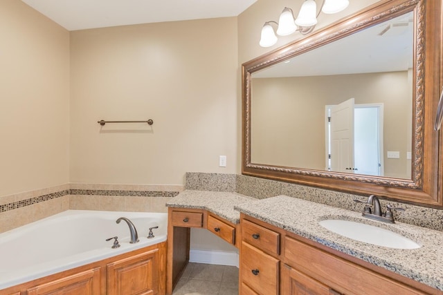 bathroom featuring tile patterned flooring, vanity, and a bathtub