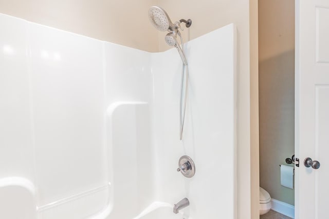 bathroom featuring toilet and shower / washtub combination